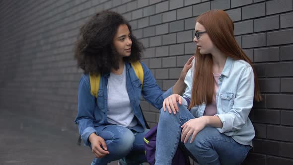 Kind Afro-American Teenager Helping Sad Female Classmate, New School Adjustment alt