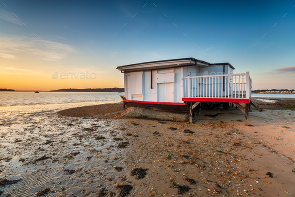 An old houseboat moored on the beach at Studland - Stock Photo - Images