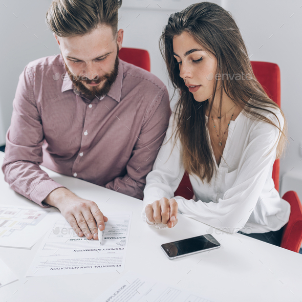 Couple Signing Mortgage Contract - Stock Photo - Images