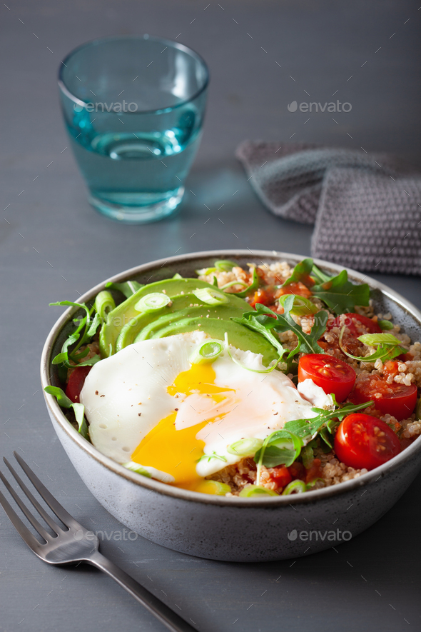 quinoa bowl with fried egg, avocado, tomato, rocket. Healthy veg