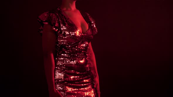 Woman in Sparkly Dress in Red Light in Nightclub