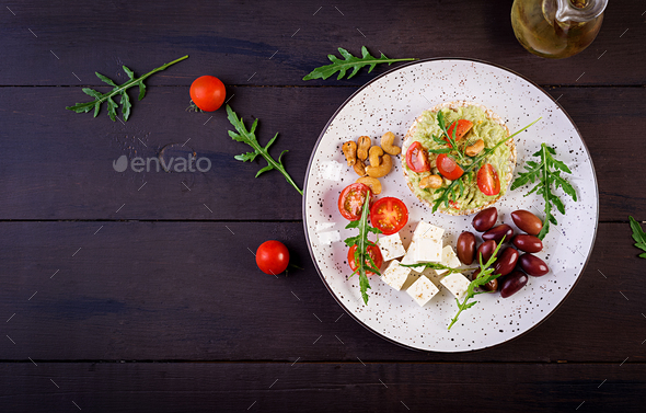 Healthy avocado toasts for breakfast or lunch, guacamole avocado, kalamata olives, tomatoes - Stock Photo - Images