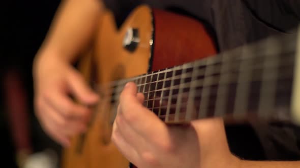 Male Guitarist Plays the Guitar in the Dark. Kyiv. Ukraine alt