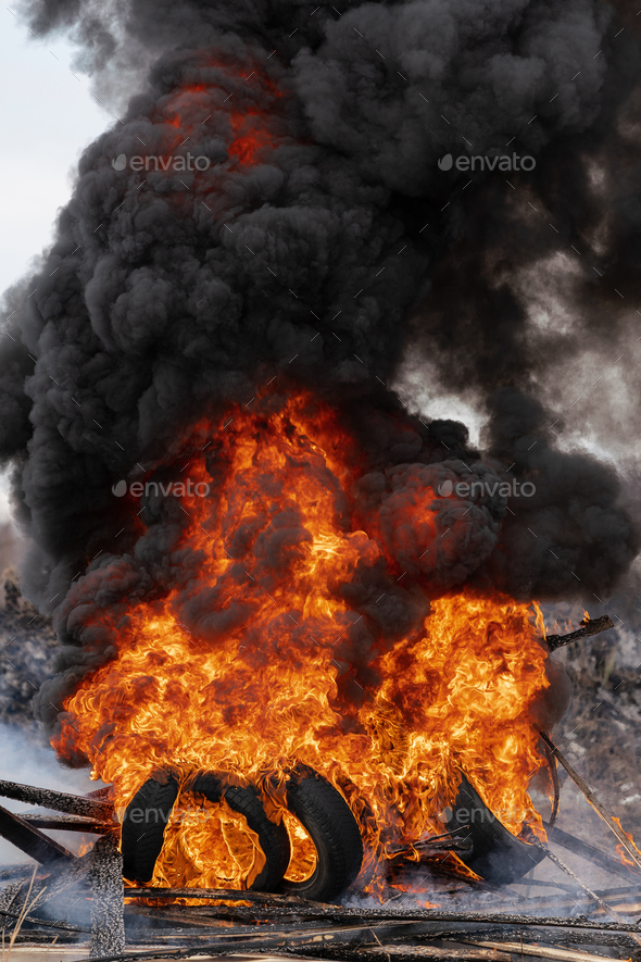 Burning Automobile Tires, Strong Flame of Red Fire and Clouds of Black Fumes