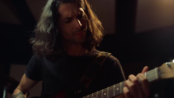 Emotional Musician Playing Guitar in Studio. Composer Producing Music Indoor alt