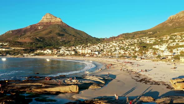 Sunny Camps Bay Beach As the Sun is Setting with Lion's Head As Backdrop