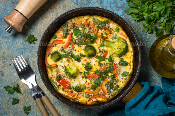 Frittata with fresh vegetables in the skillet - Stock Photo - Images