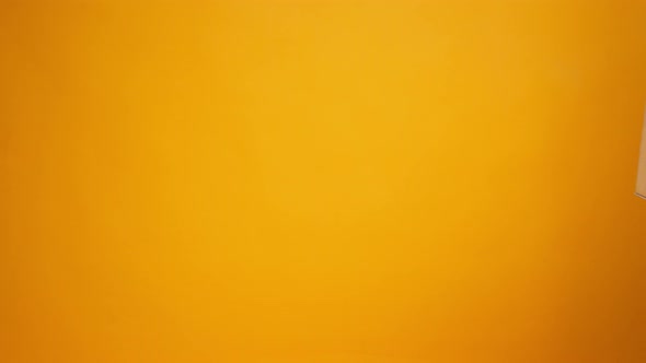 Human Hands Holding Cardboard Box with Coronavirus Donations Against Yellow Background alt