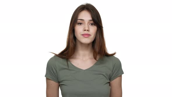 Portrait of Joyous Woman 20s with Long Aubur Hair Wearing Casual Tshirt Looking on Camera and alt