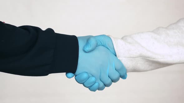 Handshake in Medical Gloves