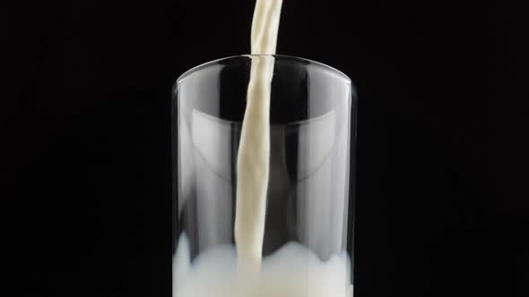 SLOW MOTION: Pouring milk in the glass