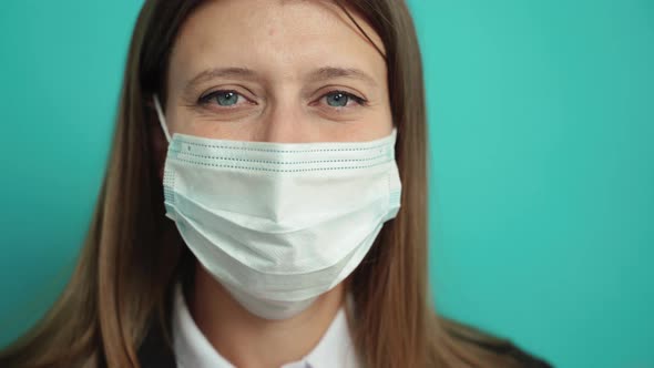 Beautiful Business Woman In Black Suit Takes Off Protective Mask alt