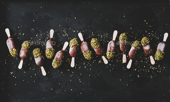 Chocolate glazed ice cream pops over black background, top view - Stock Photo - Images
