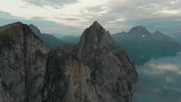 Approach to a rocky peak from an aerial flight view in Senja, Norway alt