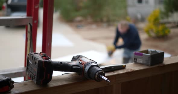 A construction worker grinding metal and making sparks fly on a job site with a drill and tools in t alt