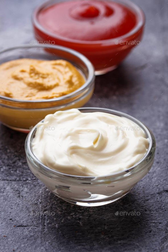 Set of different sauces: mustard, ketchup, mayonnaise. - Stock Photo - Images