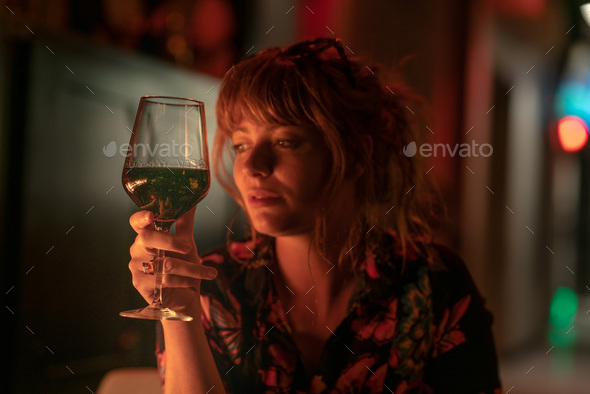 Glass of red wine with beautiful ginger girl holding in the back - Stock Photo - Images
