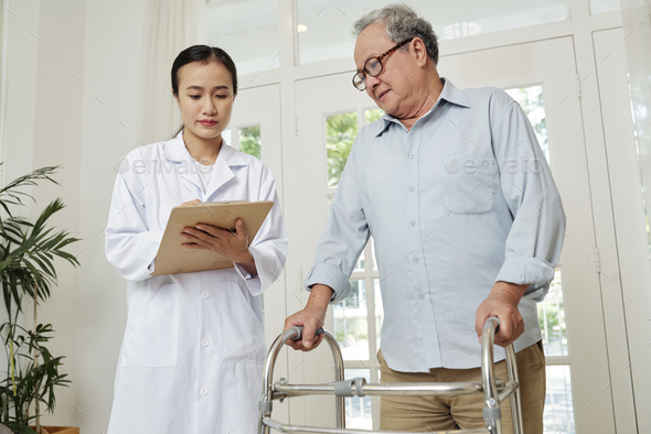 Doctor controlling the health an elderly patient - Stock Photo - Images
