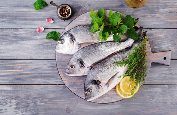 Dorado fish on cutting board.  Food Images ~ Creative Market