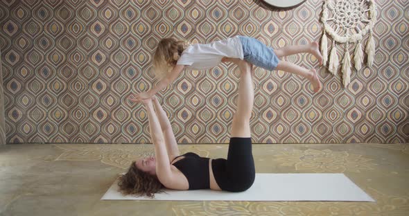Modern Happy Healthy Family Kid Son and Young Mother Having Fun Doing Yoga Exercises Together