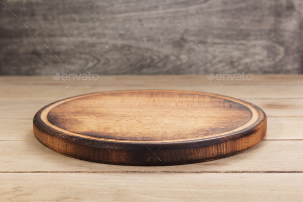 pizza cutting board at rustic wooden table Stock Photo by seregam