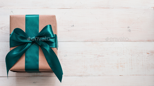 Gift box in craft paper and satin ribbon - Stock Photo - Images