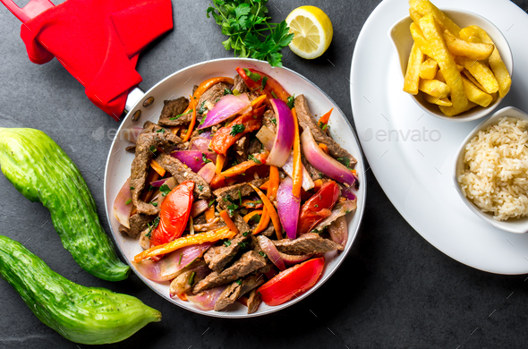 Peruvian dish Lomo saltado - beef tenderloin with vegetables - Stock Photo - Images