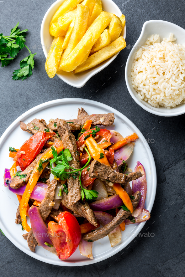 Peruvian dish Lomo saltado - beef tenderloin with vegetables - Stock Photo - Images