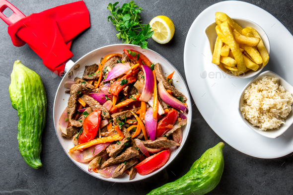 Peruvian dish Lomo saltado - beef tenderloin with vegetables - Stock Photo - Images