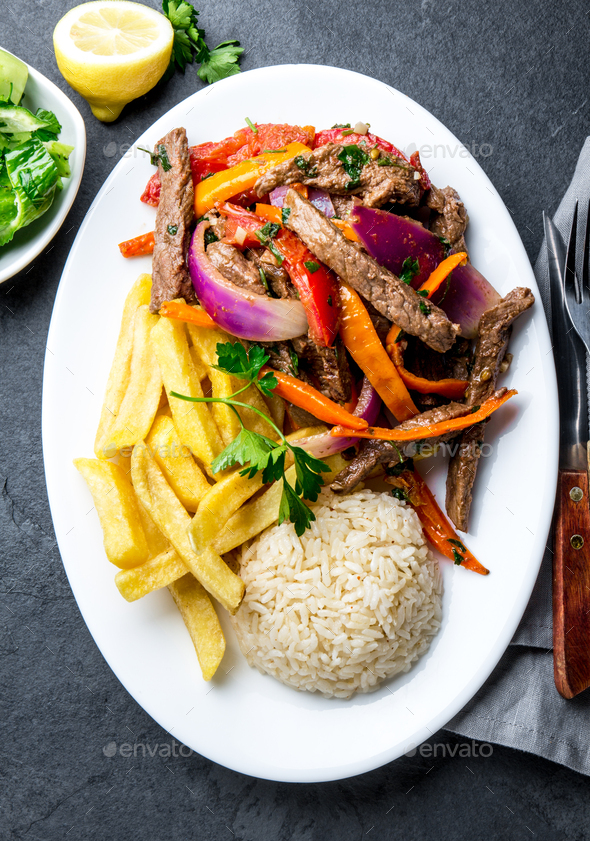 Peruvian dish Lomo saltado - beef tenderloin with vegetables - Stock Photo - Images