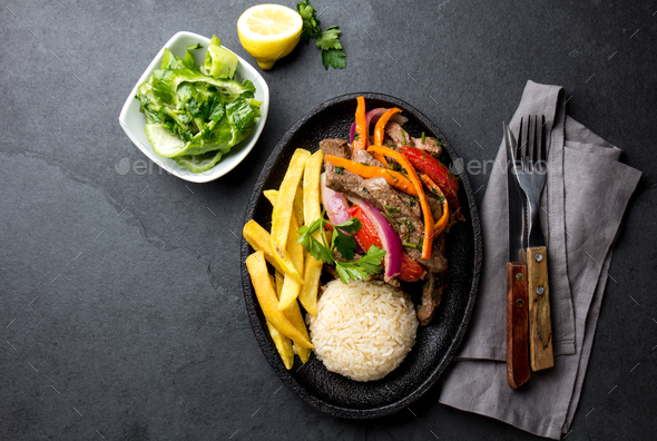 Peruvian dish Lomo saltado - beef tenderloin with vegetables - Stock Photo - Images