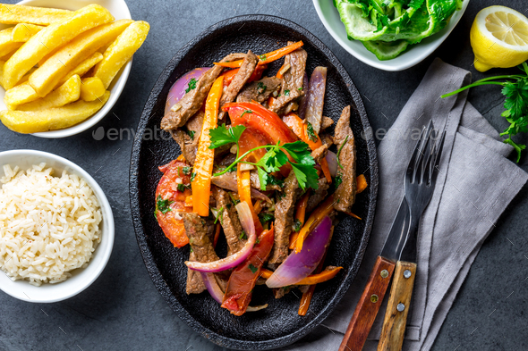 Peruvian dish Lomo saltado - beef tenderloin with vegetables - Stock Photo - Images