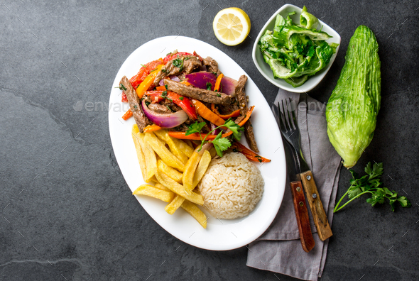 Peruvian dish Lomo saltado - beef tenderloin with vegetables - Stock Photo - Images