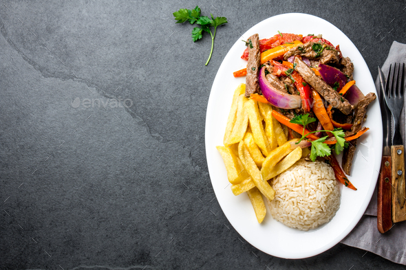 Peruvian dish Lomo saltado - beef tenderloin with vegetables - Stock Photo - Images