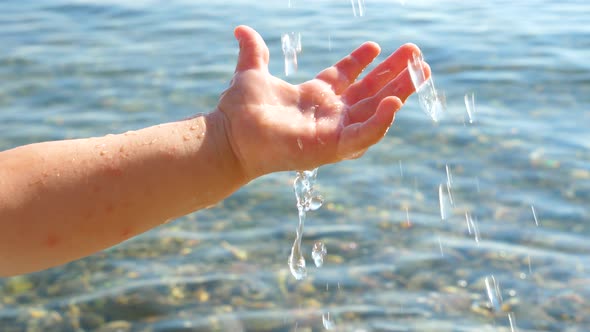 Toddler's Hand Playing with Water alt