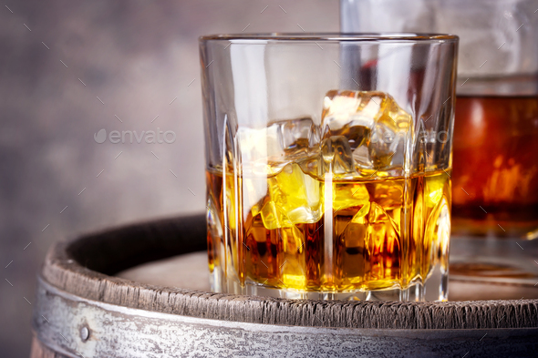 https://s3.envato.com/files/268979938/Faceted%20glass%20of%20whiskey%20with%20ice.jpg