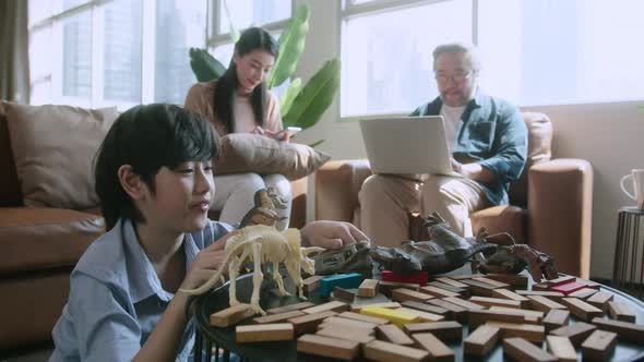 happiness son kid playing model while parents relaxing sofa at home together, alt