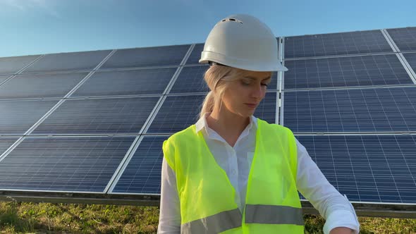 Portrait of Beautiful Female Engineer Technologist Standing Among Solar Panels