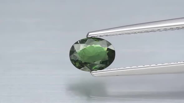 Natural Green Chrome Tourmaline in the Tweezers on the Turn Table