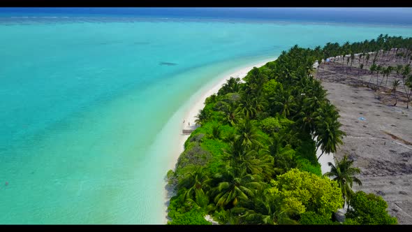 Aerial texture of idyllic tourist beach vacation by blue green lagoon with white sandy background of alt