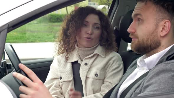Man and Woman Emotionally Sort Things Out While Sitting in Their Car alt