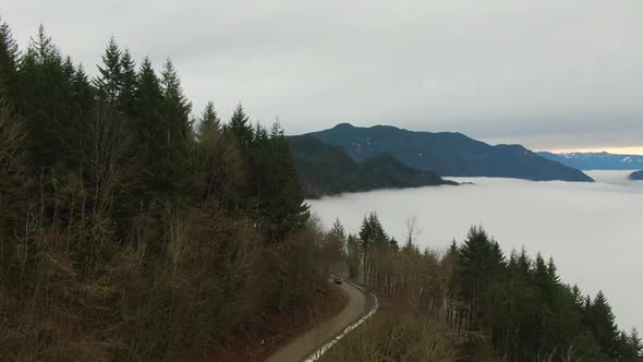Aerial View of Canadian Mountain Landscape Covered in Fog Over Harrison Lake alt