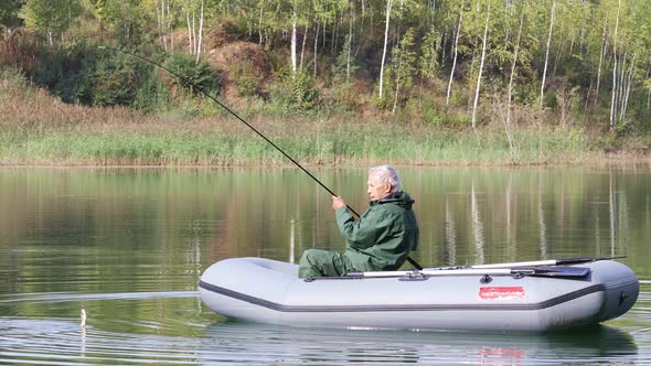 Senior Fisherman Fishing On The Lake