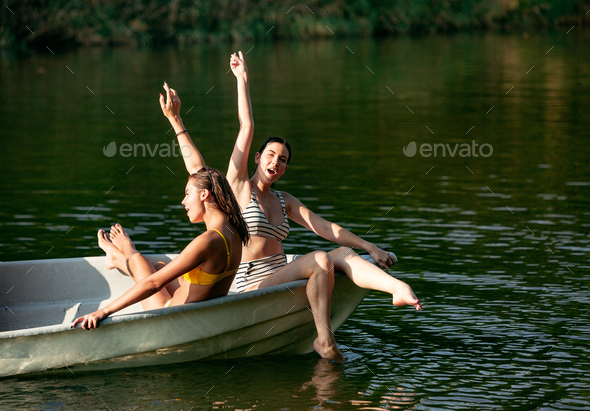 Happy group of friends having fun, laughting and swimming in river - Stock Photo - Images