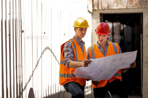 Structural engineer and construction manager dressed in work clothes and hard bats explore - Stock Photo - Images