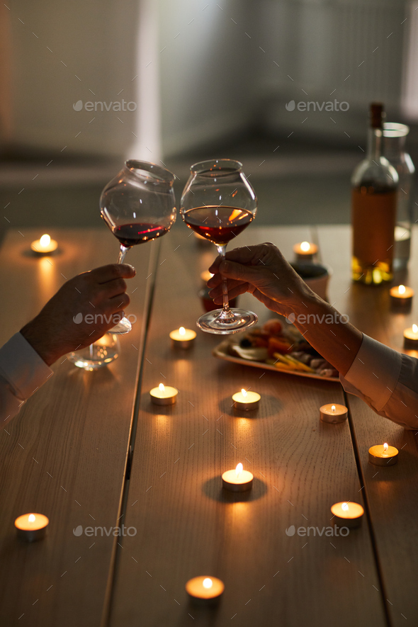 Couple Drinking Wine at Romantic Date Stock Photo by seventyfourimages
