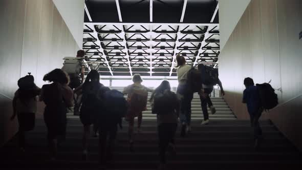 Teenage Students Running Upstairs in School Corridor alt