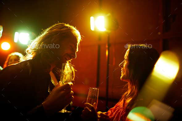 Man picking up girl at party - Stock Photo - Images