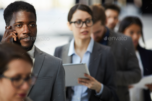 Business forum participants waiting for registration in line - Stock Photo - Images