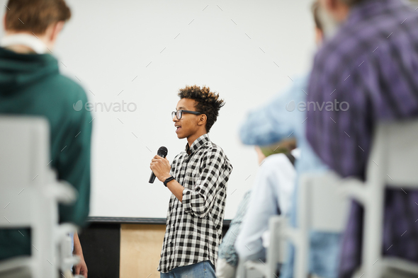 Young student presenting his startup project at conference - Stock Photo - Images